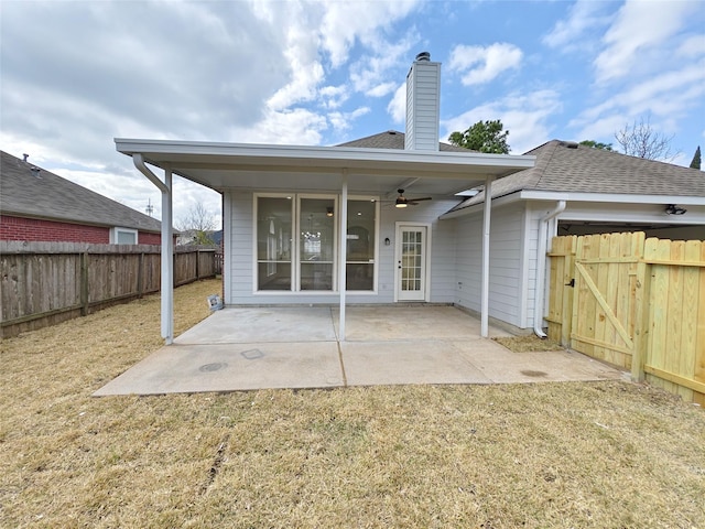 rear view of house with a patio area, ceiling fan, and a lawn