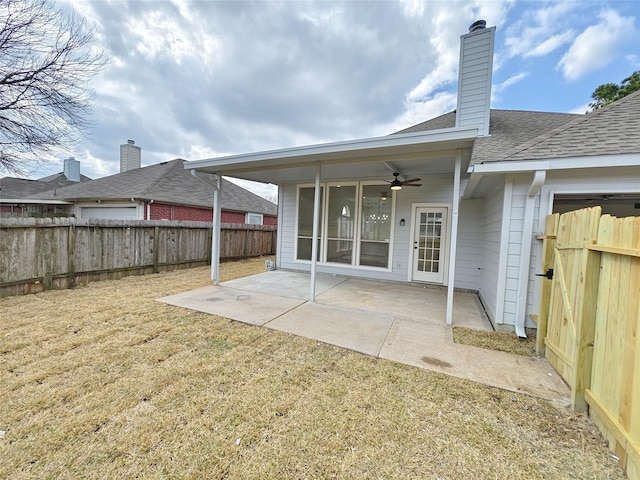 back of property with a lawn, a patio, and ceiling fan