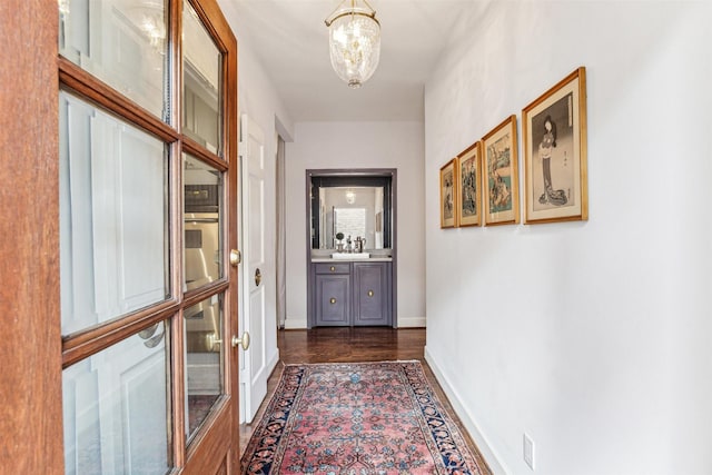 corridor featuring a notable chandelier