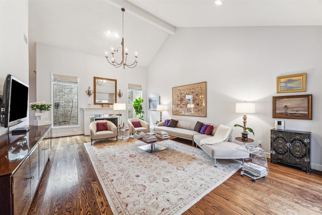 living room with an inviting chandelier, hardwood / wood-style flooring, high vaulted ceiling, and beamed ceiling