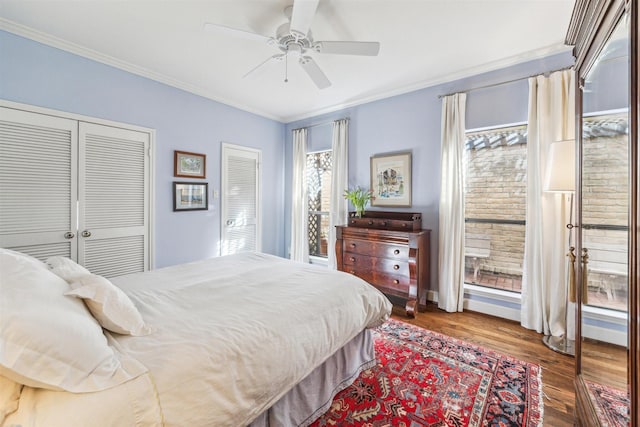 bedroom featuring ceiling fan, ornamental molding, and wood-type flooring