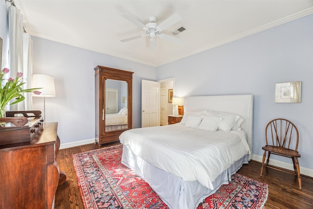 bedroom featuring ornamental molding, ceiling fan, and dark hardwood / wood-style flooring