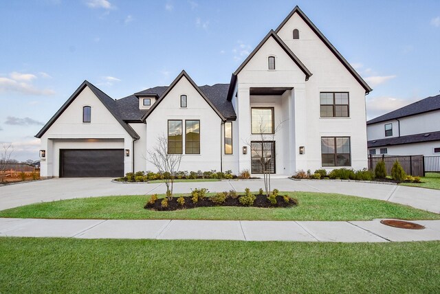 view of front facade featuring a garage and a front lawn