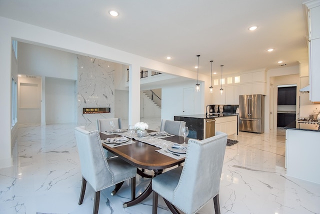 dining room with sink and a premium fireplace