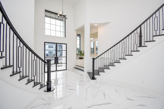 foyer entrance featuring a high ceiling and a chandelier