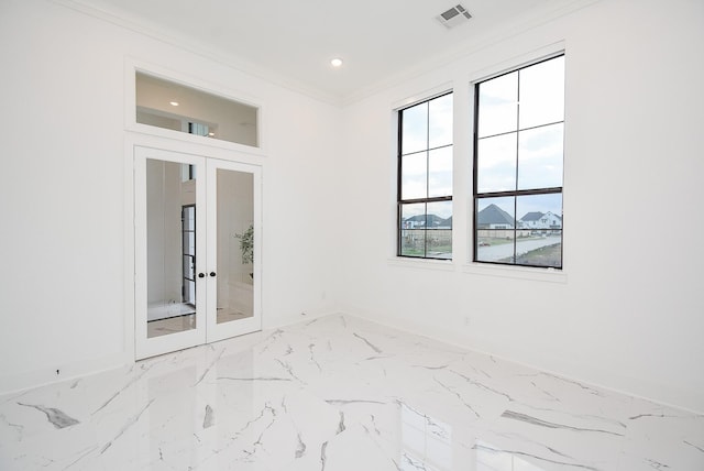 spare room featuring a mountain view, ornamental molding, and french doors