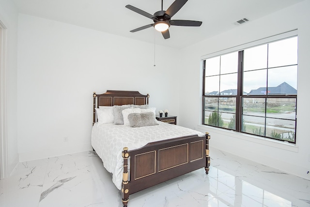 bedroom with ceiling fan and a mountain view