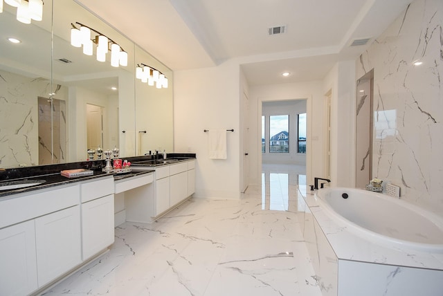 bathroom with vanity and a tub to relax in