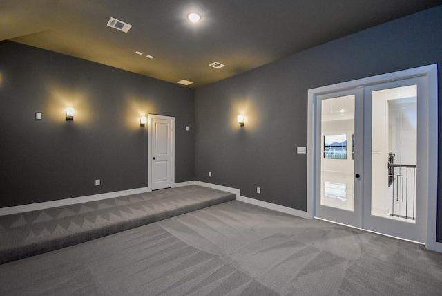 carpeted home theater with french doors