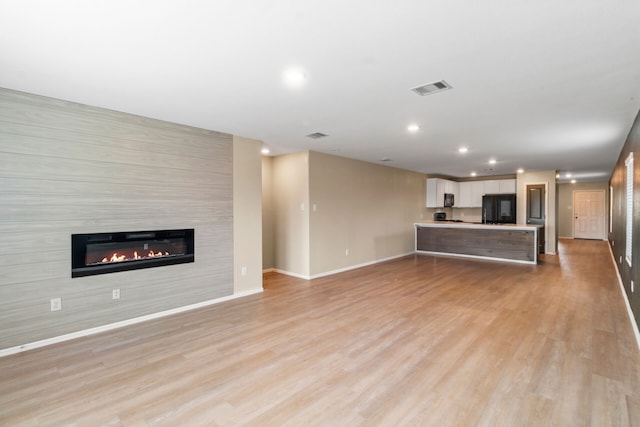 unfurnished living room featuring light hardwood / wood-style floors