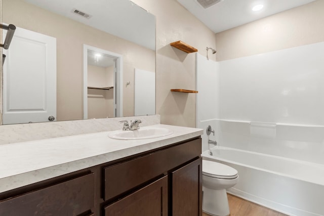 full bathroom with vanity, hardwood / wood-style floors, tub / shower combination, and toilet