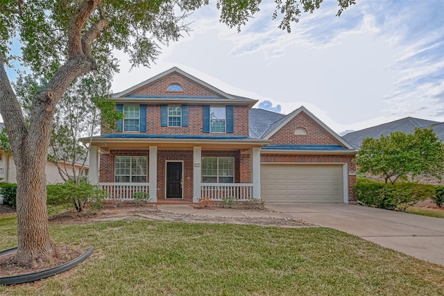 view of front of house with a garage, a front yard, and covered porch