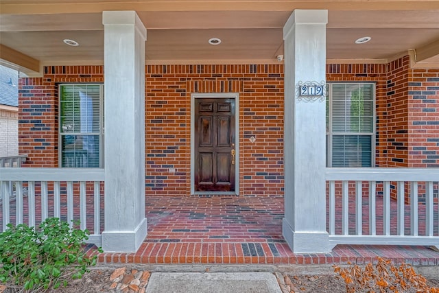 view of exterior entry with covered porch