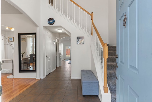 tiled entryway with a high ceiling