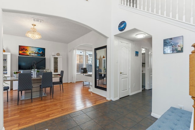 dining space featuring dark hardwood / wood-style floors and a notable chandelier