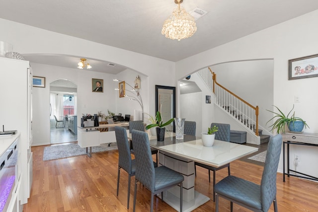 dining room with a chandelier and light hardwood / wood-style floors