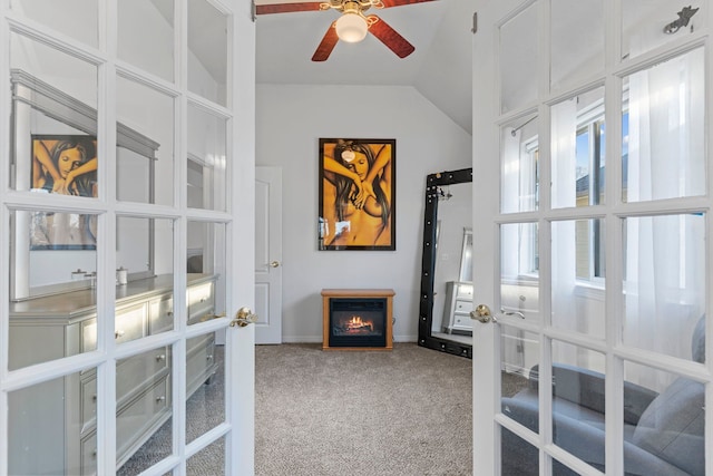 carpeted office featuring french doors, ceiling fan, and vaulted ceiling