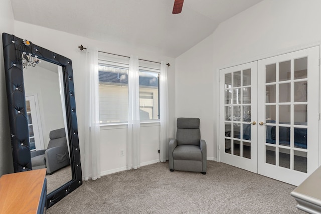 sitting room with french doors, carpet flooring, and vaulted ceiling