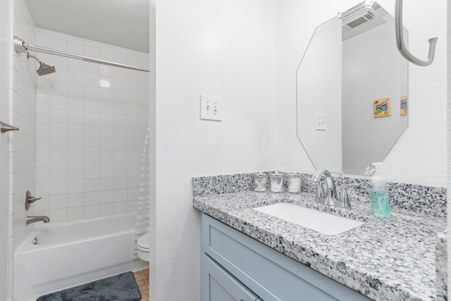 full bathroom with vanity, toilet, and tiled shower / bath combo