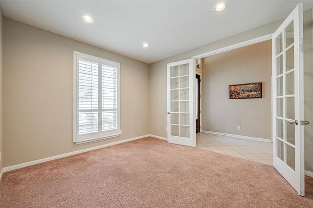 carpeted empty room with french doors