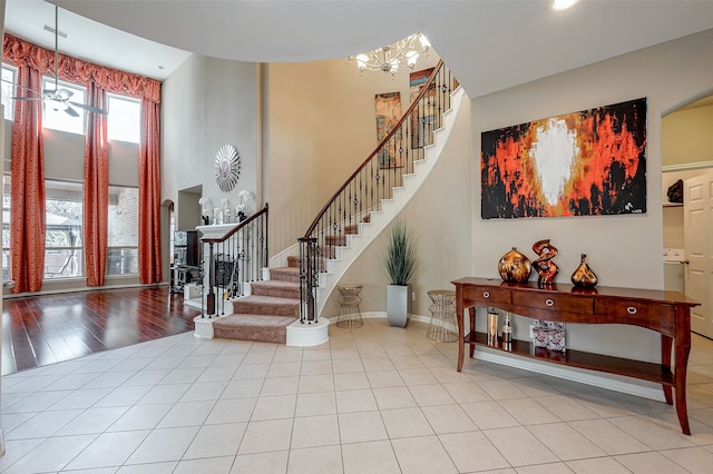 tiled entrance foyer featuring a high ceiling