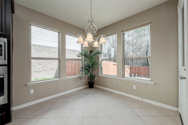 unfurnished dining area featuring plenty of natural light and a chandelier