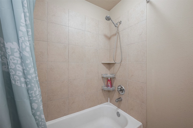 bathroom with shower / bath combo with shower curtain