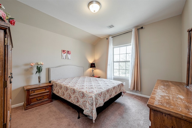 bedroom with lofted ceiling and light colored carpet