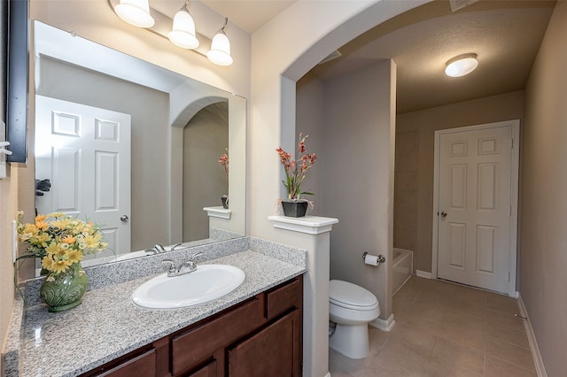 bathroom with tile patterned flooring, vanity, and toilet