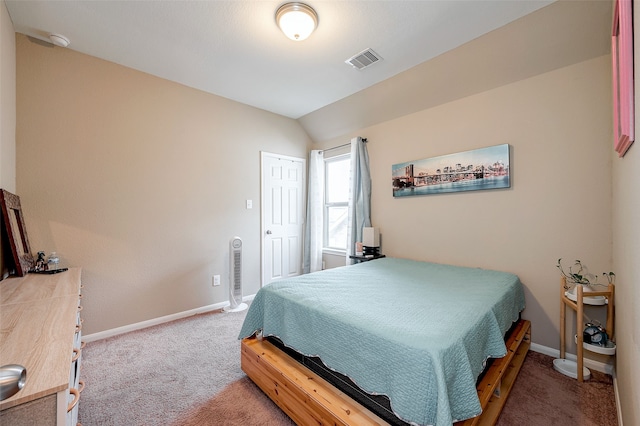 bedroom with lofted ceiling and carpet floors