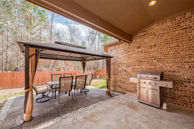 view of patio featuring a gazebo and a grill