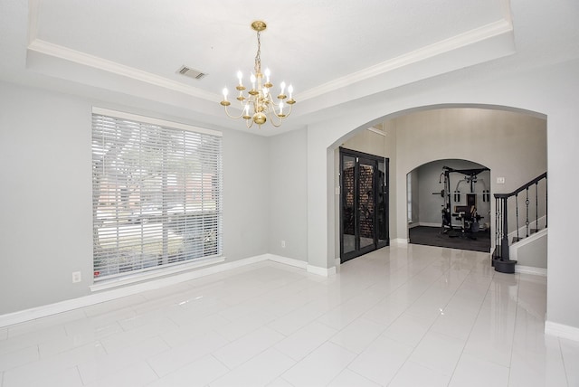 unfurnished room featuring crown molding and a raised ceiling