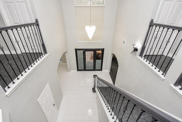 tiled foyer with a high ceiling