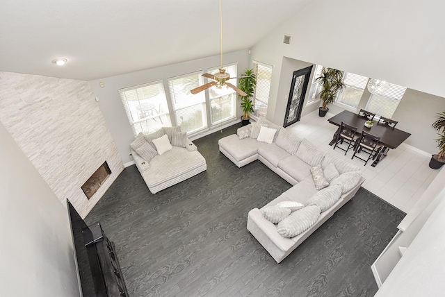 living room with dark hardwood / wood-style flooring and high vaulted ceiling