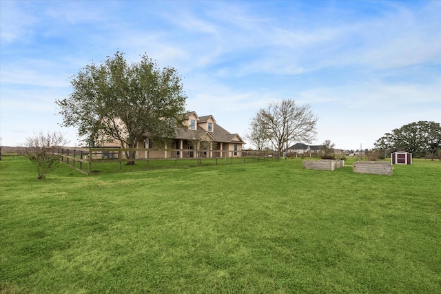 view of yard featuring a shed and a rural view