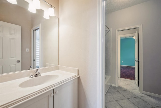 bathroom with vanity, tile patterned flooring, and a textured ceiling