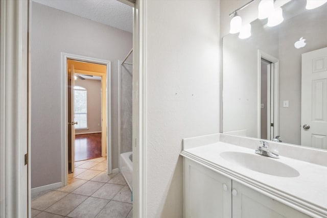 bathroom with vanity, tub / shower combination, tile patterned floors, and a textured ceiling