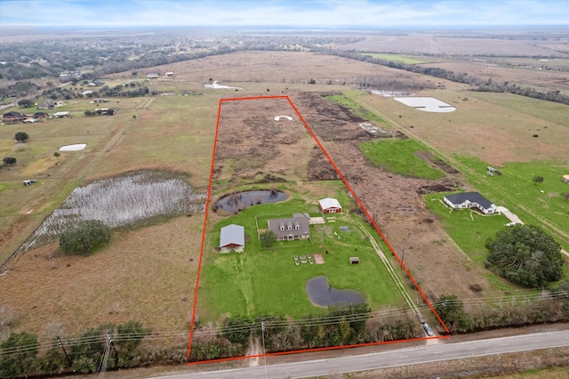 birds eye view of property with a rural view