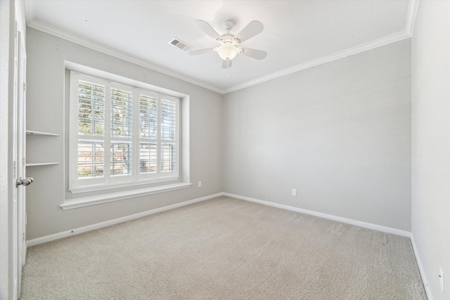 empty room featuring crown molding, light carpet, and ceiling fan