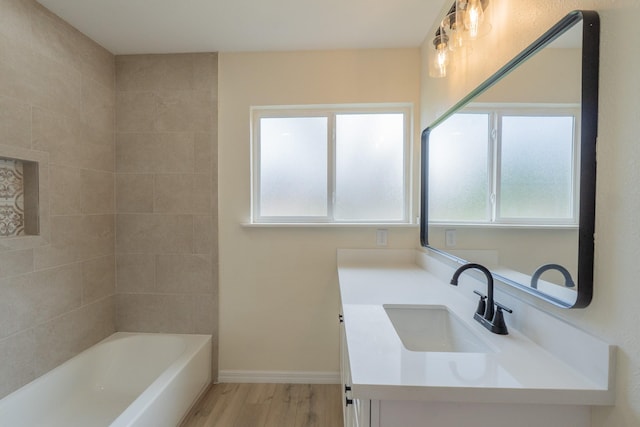 bathroom featuring hardwood / wood-style flooring, vanity, and plenty of natural light