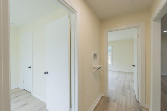 hallway with light wood-type flooring