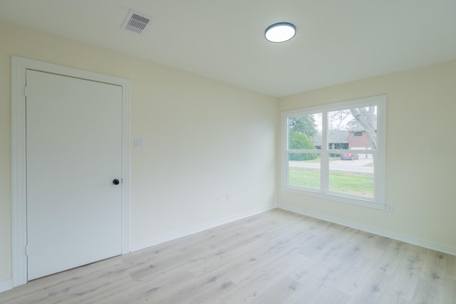 spare room featuring light hardwood / wood-style floors