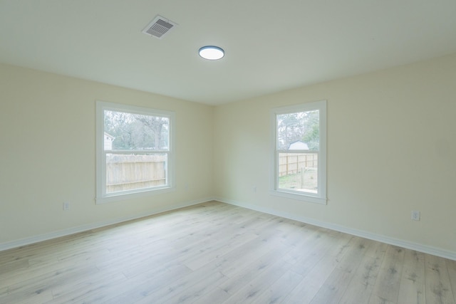 empty room with light hardwood / wood-style flooring