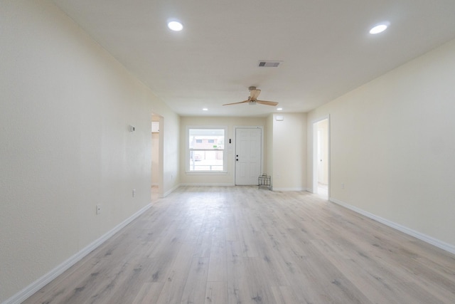 empty room featuring ceiling fan and light hardwood / wood-style floors