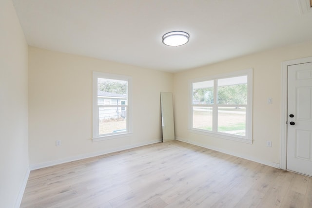 spare room with a healthy amount of sunlight and light wood-type flooring