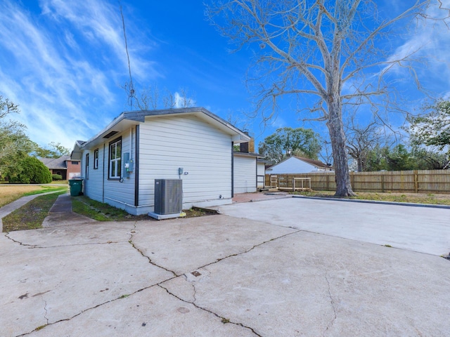 view of home's exterior with central AC unit and a patio