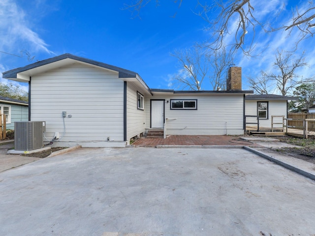 back of property featuring central air condition unit and a patio area