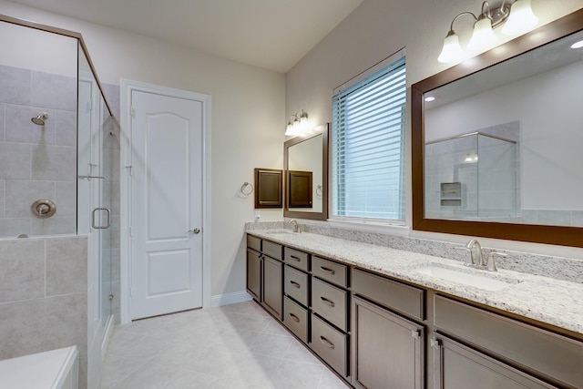 bathroom with vanity, tile patterned flooring, and a shower with door