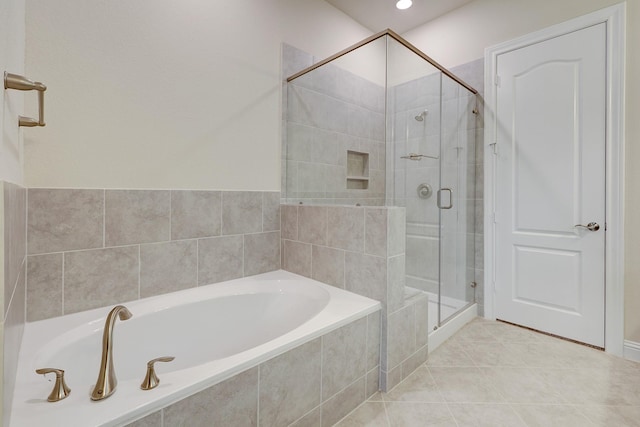 bathroom featuring tile patterned flooring and separate shower and tub