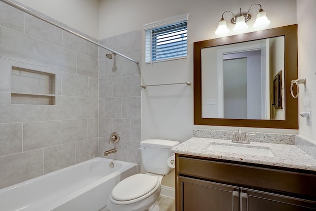 full bathroom with tiled shower / bath, vanity, and toilet